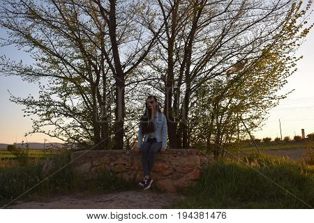 Sit woman thinking and waiting in the forest