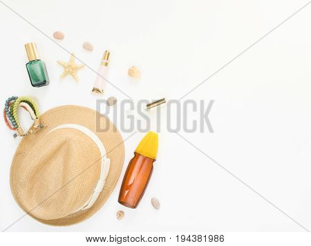 Summer background. Straw hat boho bracelet sun protection spray and cosmetics. Flat lay top view.