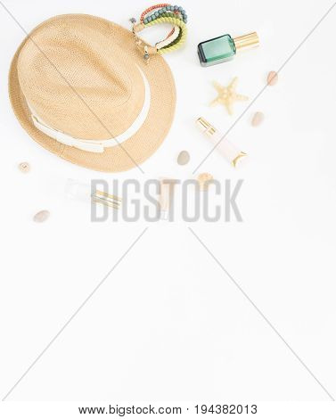 Summer background. Straw hat boho bracelet and cosmetic bottles. Flat lay top view.