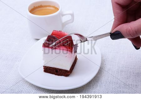 Slice of handmade cherry pie on a plate in white background.