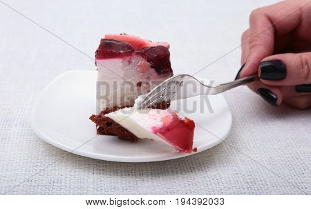 Slice of handmade cherry pie on a plate in white background.