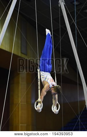 Kyiv. Ukraine-April 1, 2017 : Male gymnast performing on stationary gymnasic rings during Stella Zakharova Artistic Gymnastics Cup