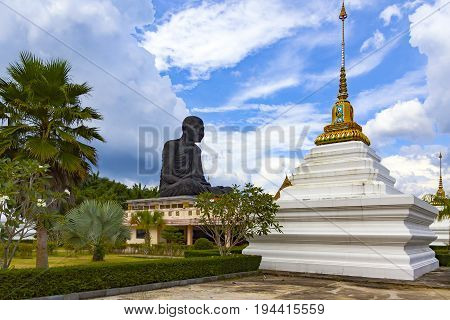 Temple of the black monk in Thailand a very large statue of a monk