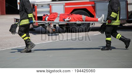 Firefighters During The Exercise To Carry The Injured With The S