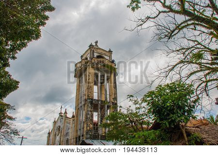 Catholic Cathedral On The Background Of Tree Branches In The Philippines. Pandan, Panay