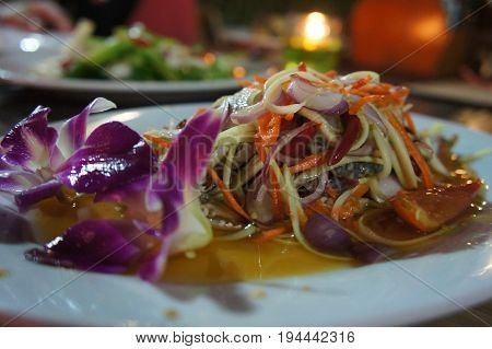 salad papaya or papaya horse crab and orchid decoration white dish thailand dinner