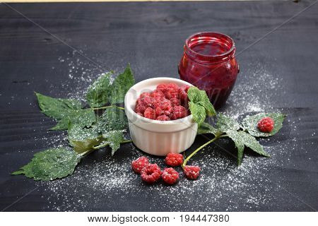 Ripe and tasty raspberries on a wooden background. Raspberries on wooden table .Fresh , vitamins healthy food vegan ingredients.