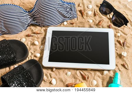 Summer bikini and accessories stylish beach set, Beach bikini summer outfit and sea sand as background, Top View, Concept. Copy space