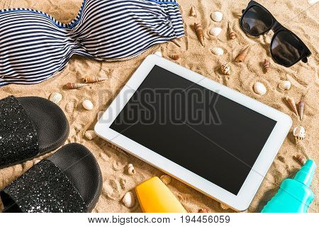 Summer bikini and accessories stylish beach set, Beach bikini summer outfit and sea sand as background, Top View, Concept. Copy space