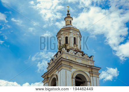Ancient tower of an abandoned Orthodox church against the sky, toned