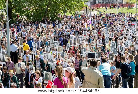 Udomlya City, Russia - 9 May 2016: Victory Day: Parade of an immortal regiment in the city of Udomlya. People with portraits of those killed in the Second World War.