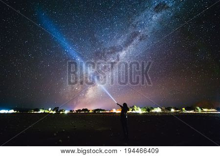 Girl With Flashlight Pointing To The Galaxy At The Sky.  Milky Way Over Sesriem Camping Site, Namibi