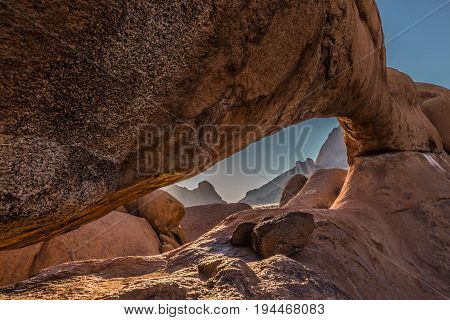 Natural Array Of Bald Granite Among The Namib Desert. Stone Arch Spitzkoppe, Namibia. The Concept Of