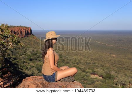 Girl Sitting On Stone On The Cliff At An Forest Landscape.