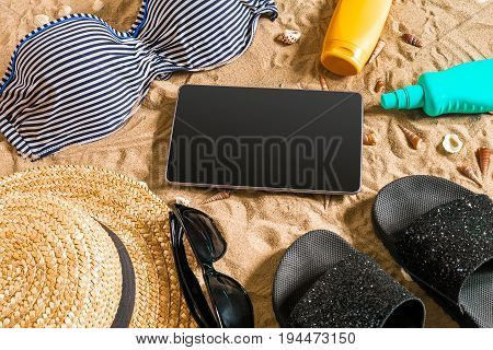 Summer bikini and accessories stylish beach set, Beach bikini summer outfit and sea sand as background, Top View, Concept. Copy space