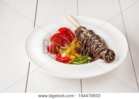 Soba noodles of buckwheat Noodles of buckwheat yellow pepper, tomato and herbs. Pan-Asian cuisine. Place for text. Square photo size. Copy space