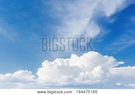 Bright sunny day with white fluffy clouds. Cloudscape on blue sky.