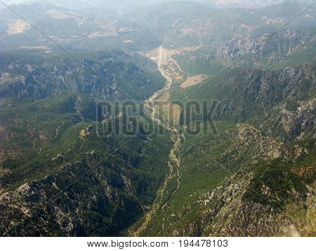 panoramic view of high mountains out of plane's window