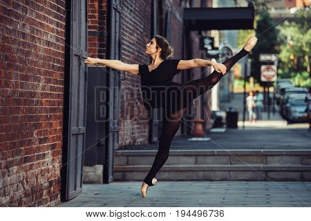 Elegant ballet dancer woman dancing ballet in the city