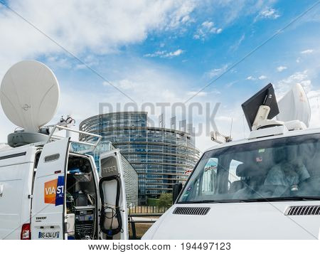 STRASBOURG FRANCE - JUN 30 2017: TV Media Television Trucks with multiple equipment Satellite parabolic antennas and fiber optic cables preparing to report live the official European Ceremony of Honour for Dr. Helmut Kohl at European Parliament