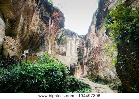 The exploitation of limestone hills canyon forming a unique architectural in Arosbaya Hill Madura Island, Indonesia