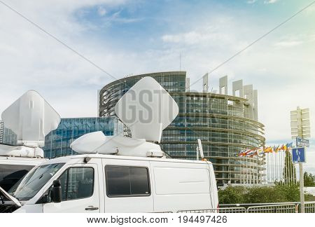 TV Media Television Trucks with multiple Satellite parabolic antennas and fiber optic cables preparing to report live the official European Ceremony debate government decision