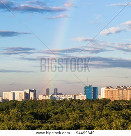 Rainbow In Blue Sky Over Modern Houses