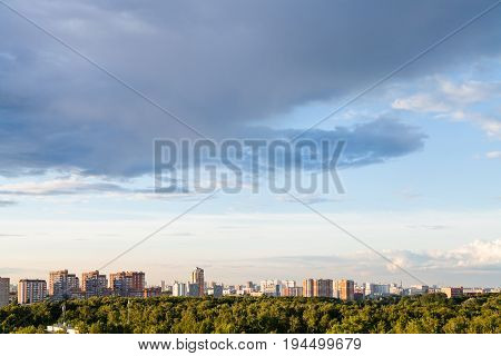 Rainy Gray Cloud In Blue Evening Sky Over City