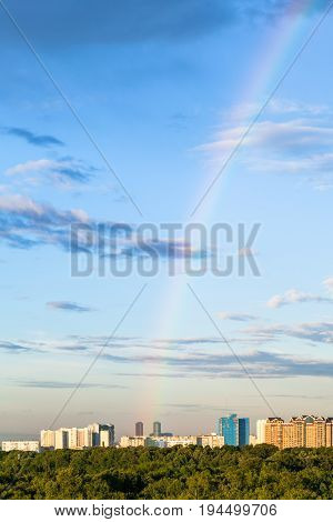 Rainbow In Evening Sky Over Apartment Buildings