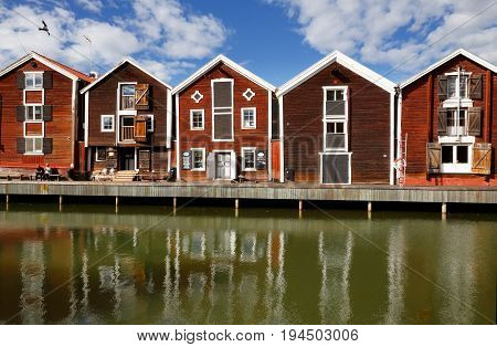 Hudiksvall Sweden - July 5 2017: Old red warehouses built of wood next to the water.