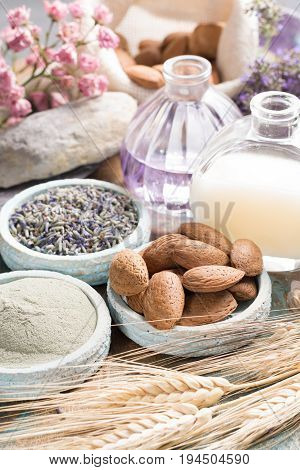 Nature cosmetics handmade preparation with essential oils and ancient minerals of perfume skincare creams soaps from fresh and dried lavender flowers roses wheat almond nuts green clay powder in French artisanal boutique home style