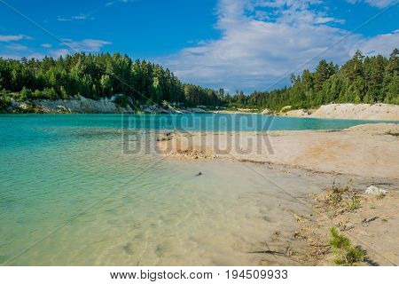A beach on the azure quarry formed on the site of the kaolin quarry.