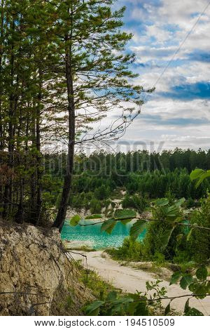 A beautiful view of the azure quarry formed at the site of the kaolin quarry.