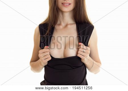 close up of young woman shows her silicon breasts isolated on white background