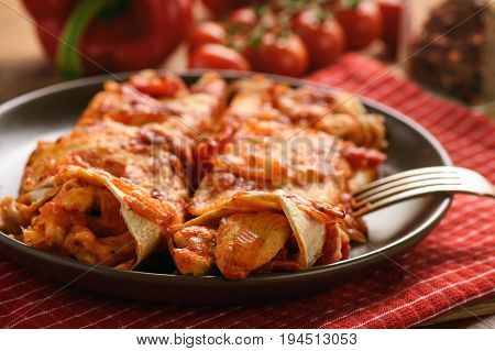 Enchiladas - mexican food, tortilla with chicken, cheese and tomatoes.