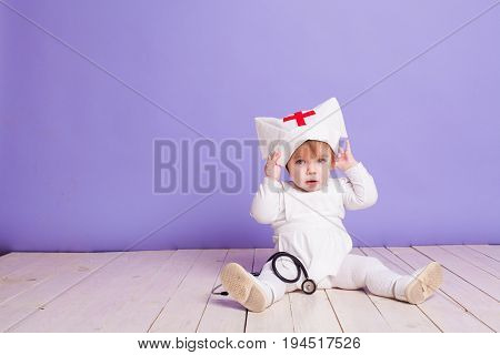 little girl plays in the hospital nurse with stethoscope