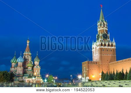 Blue hour sunset view of St. Basil Cathedral and Kremlin tower at Moscow Red Square. World famous Russian Moscow landmarks. Tourism and travel concept.