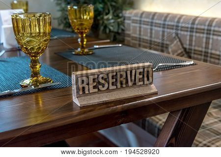 Reserved sign on a table in restaurant