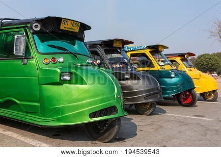 Ayutthaya, Thailand - March 3, 2017: Vintage Tuk Tuk taxi in Ayutthaya historical park. A traditional three wheel taxi car in Ayutthaya, Thailand