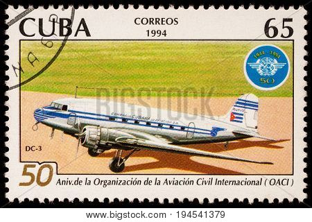 Moscow Russia - January 14 2017: A stamp printed in Cuba shows old passenger aircraft Douglas DC-3 and emblem of ICAO series 