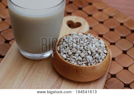 Coix lacryma-jobi, boiled in a glass on a brown background