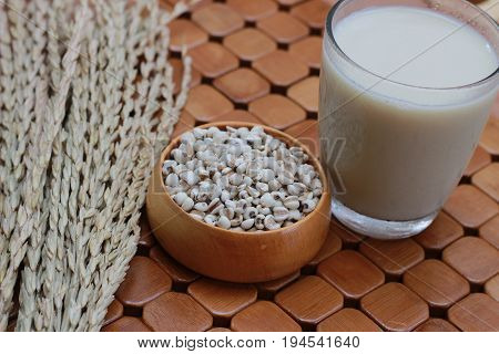 Coix lacryma-jobi, boiled in a glass on a brown background
