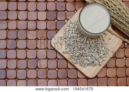 Coix lacryma-jobi, boiled in a glass on a brown background