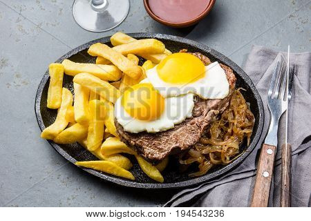Peruvian Latin American food. Lomo a lo pobre. Beef whit fried potatoes french fry and eggs