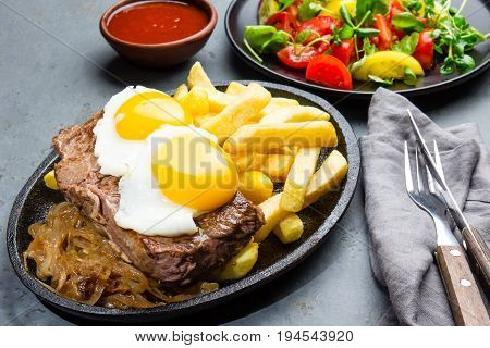 Peruvian Latin American food. Lomo a lo pobre. Beef whit fried potatoes french fry and eggs