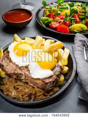 Peruvian Latin American food. Lomo a lo pobre. Beef whit fried potatoes french fry and eggs