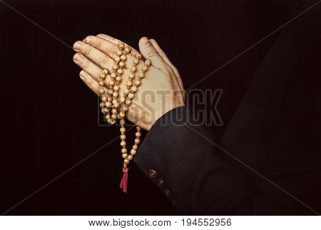 Hands Holding Rosary And Folded In Prayer