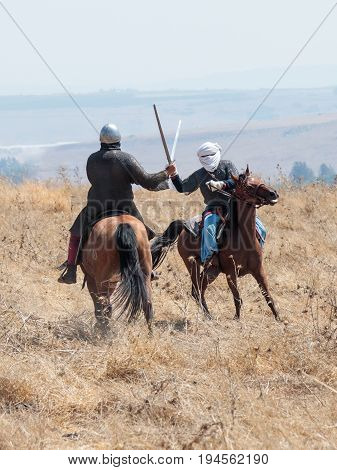 Tiberias Israel July 01 2017 : Participants in the reconstruction of Horns of Hattin battle in 1187 participate in the battle on horseback on the battlefield near Tiberias Israel