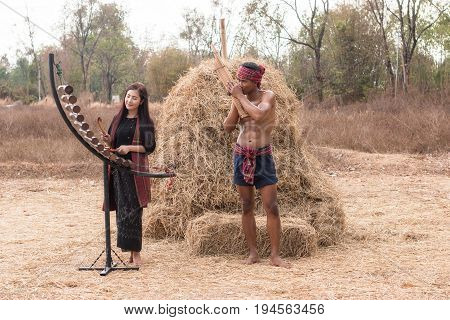 Asian beautiful girl are happy playing Pong Lang is a Thai musical instrument in summer at Countryside.