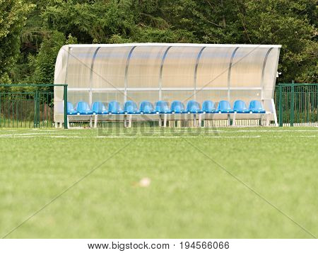 New Blue Plastic Seats On Outdoor Stadium Players Bench, Chairs Under Transparent Plastic Roof